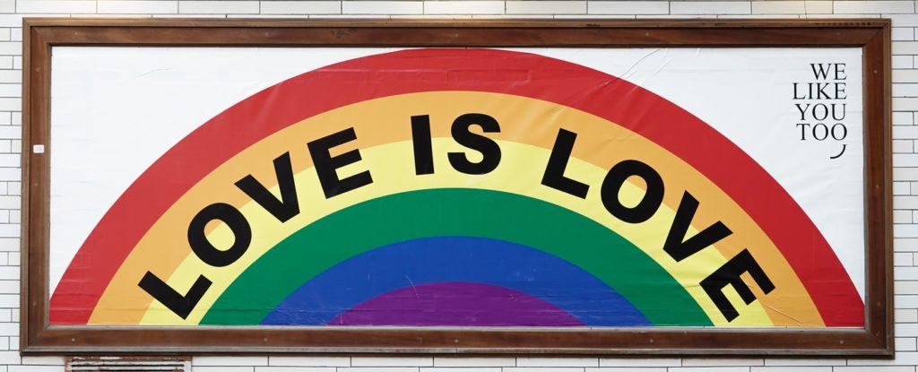 love is love wall art with brown wooden frame